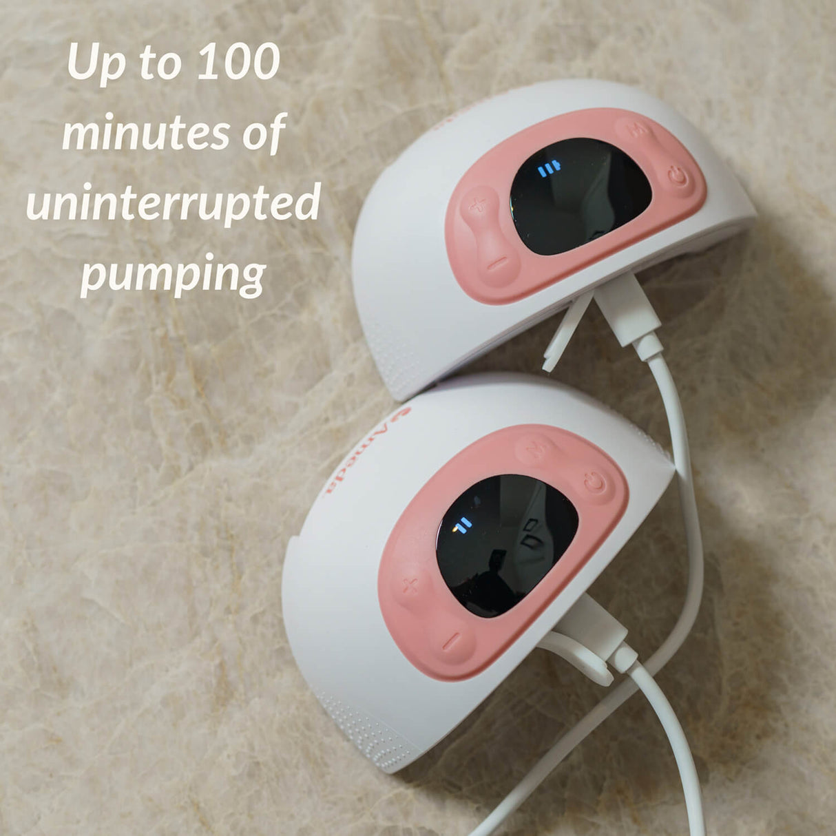 Two breast pumps with digital displays and pink accents on a countertop, with text reading "Up to 100 minutes of uninterrupted pumping" in the background.