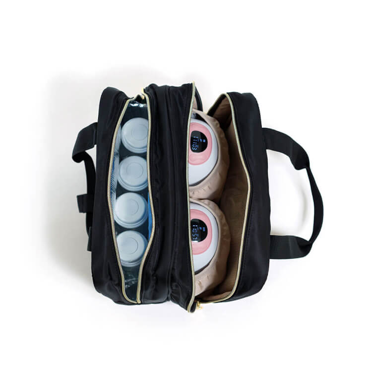 Open black bag with compartments holding bottles and electronic devices.