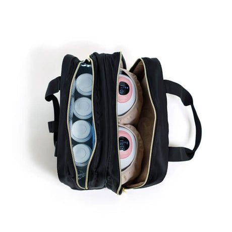 Open black bag with compartments holding bottles and electronic devices.