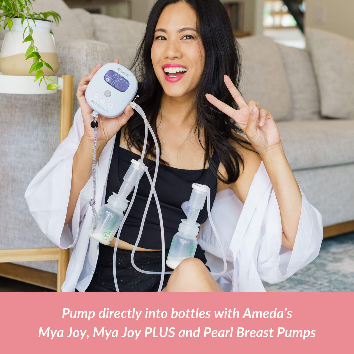Smiling woman using an Ameda double breast pump with bottles attached, holding the pump unit and flashing a peace sign, with promotional text below.