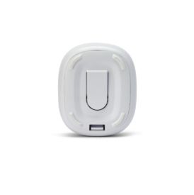 A small, oval-shaped white device with a raised button in the center and a small rectangular port at the bottom. The device has curved edges and appears to be made of plastic, suggesting it may be a wireless remote control, a smart device, or an accessory with a simple user interface.