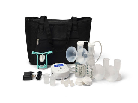 A black tote bag is placed centrally, surrounded by various components of a breast pump kit. The kit includes two clear breast pump flanges, a small white electronic unit with a digital display and buttons, and several collection bottles with lids. There are also small clear lids and connectors, as well as a power adapter with a cord. The items are organized in a way that highlights their functionality for breastfeeding mothers.