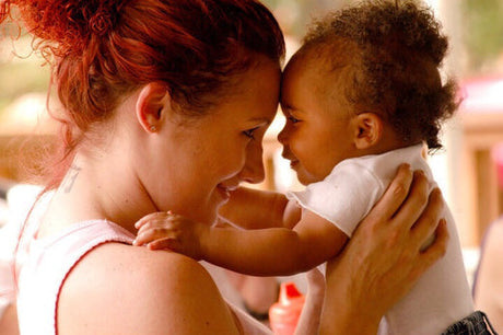 Mother and baby hugging in an intimate bonding experience