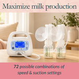 A breast pump set displayed on a wooden table in a softly lit home interior. The set includes a white digital pump with a blue display, clear flange cups, and two clear bottles with visible Arinkoo branding.