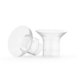 Two transparent Ameda breast pump flanges with a wide, cone-shaped design are shown; one is standing upright and the other is lying on its side, revealing a blue dot on the side.