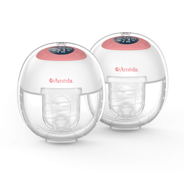 Two Ameda wearable breast pumps with a round, white and clear design, pink top panel, and digital display, designed for hands-free milk expression.