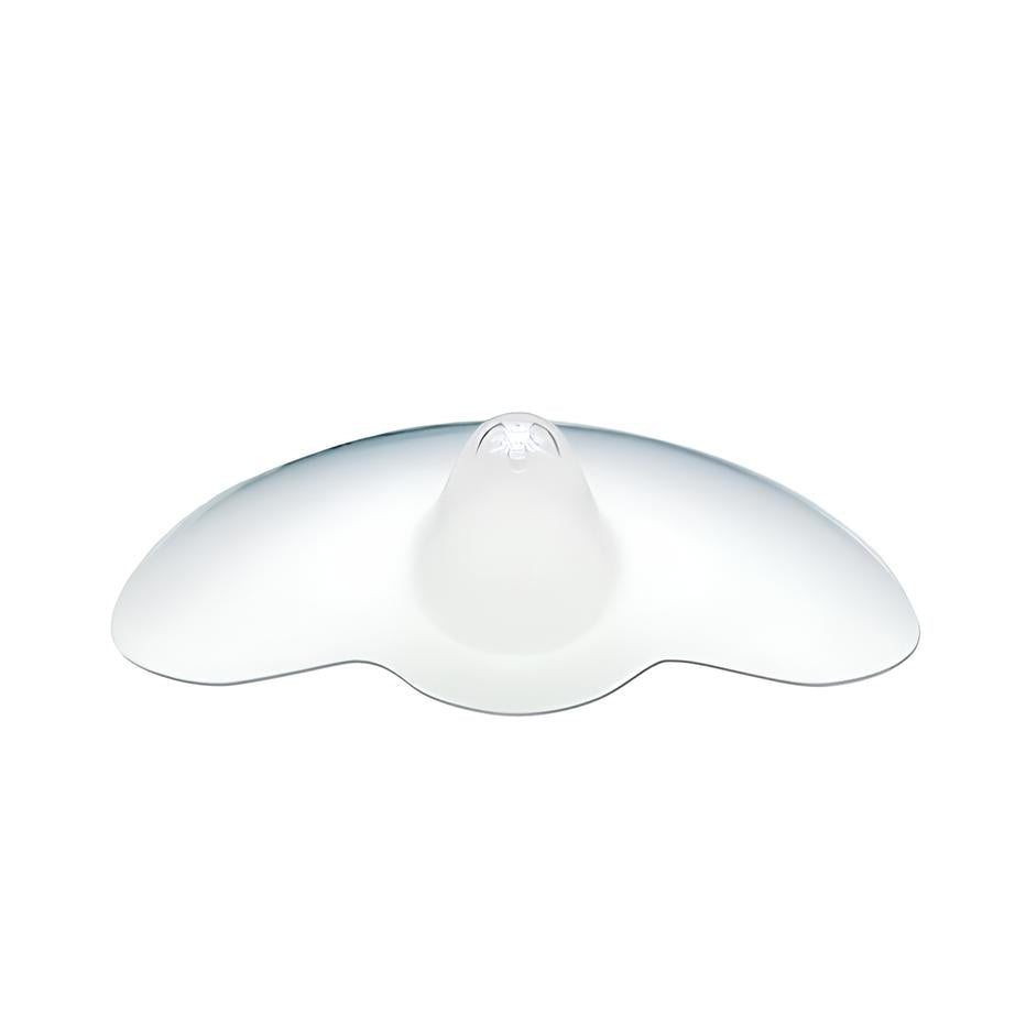 A translucent silicone nipple shield with a rounded central projection and wide, curved edges designed to aid breastfeeding. The shield has a smooth surface and is primarily clear, allowing for light to pass through.